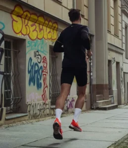 Runner experiencing knee pain from IT Band Syndrome in urban setting Physiotherapy Oakville