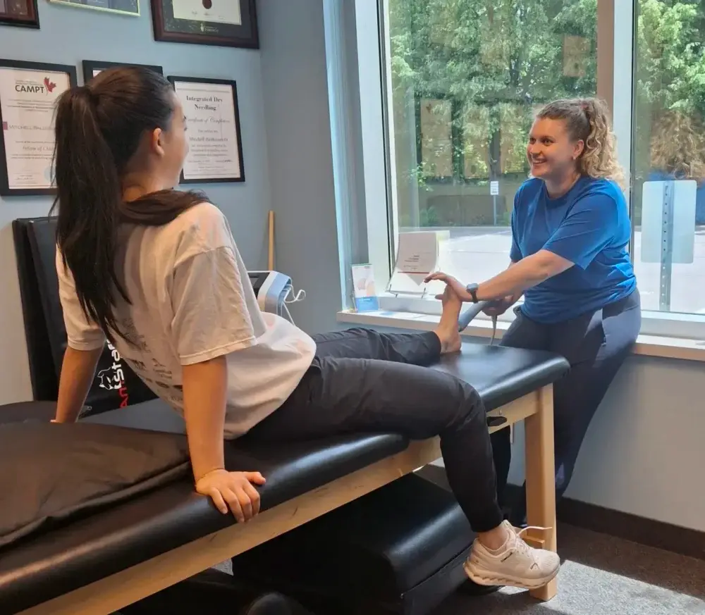 Shockwave therapy for leg pain – physiotherapist applying treatment to stimulate healing Physiotherapy Oakville