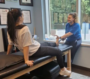 Shockwave therapy for leg pain – physiotherapist applying treatment to stimulate healing Physiotherapy Oakville