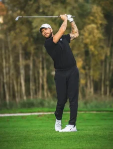Golfer mid-swing on course promoting TPI assessment